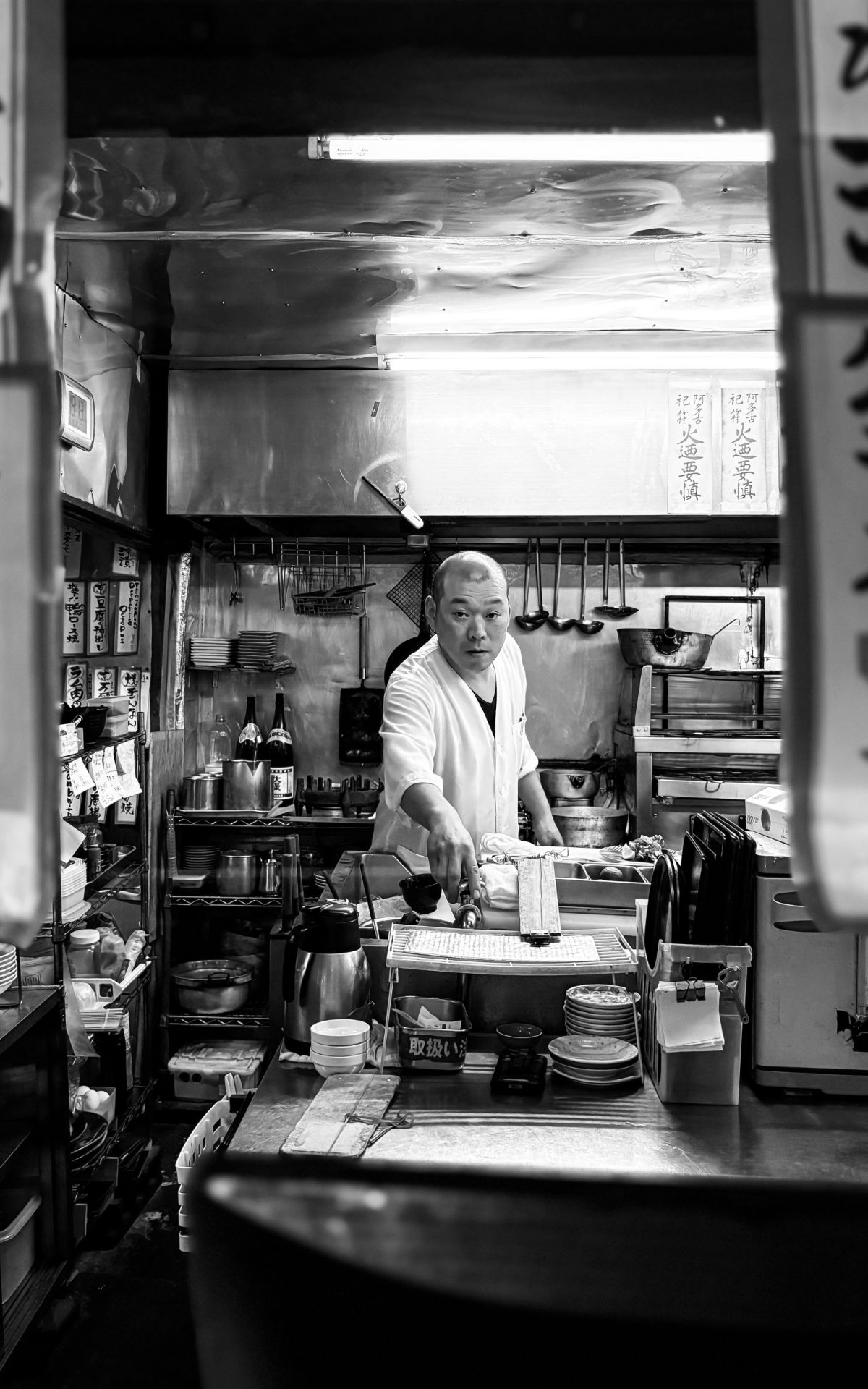 A chef mid-order in a Tokyo kitchen